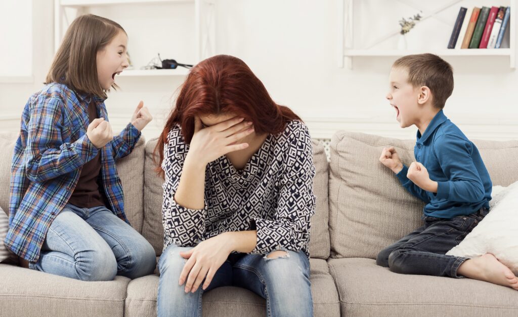 frustrated mum with poorly behaved children